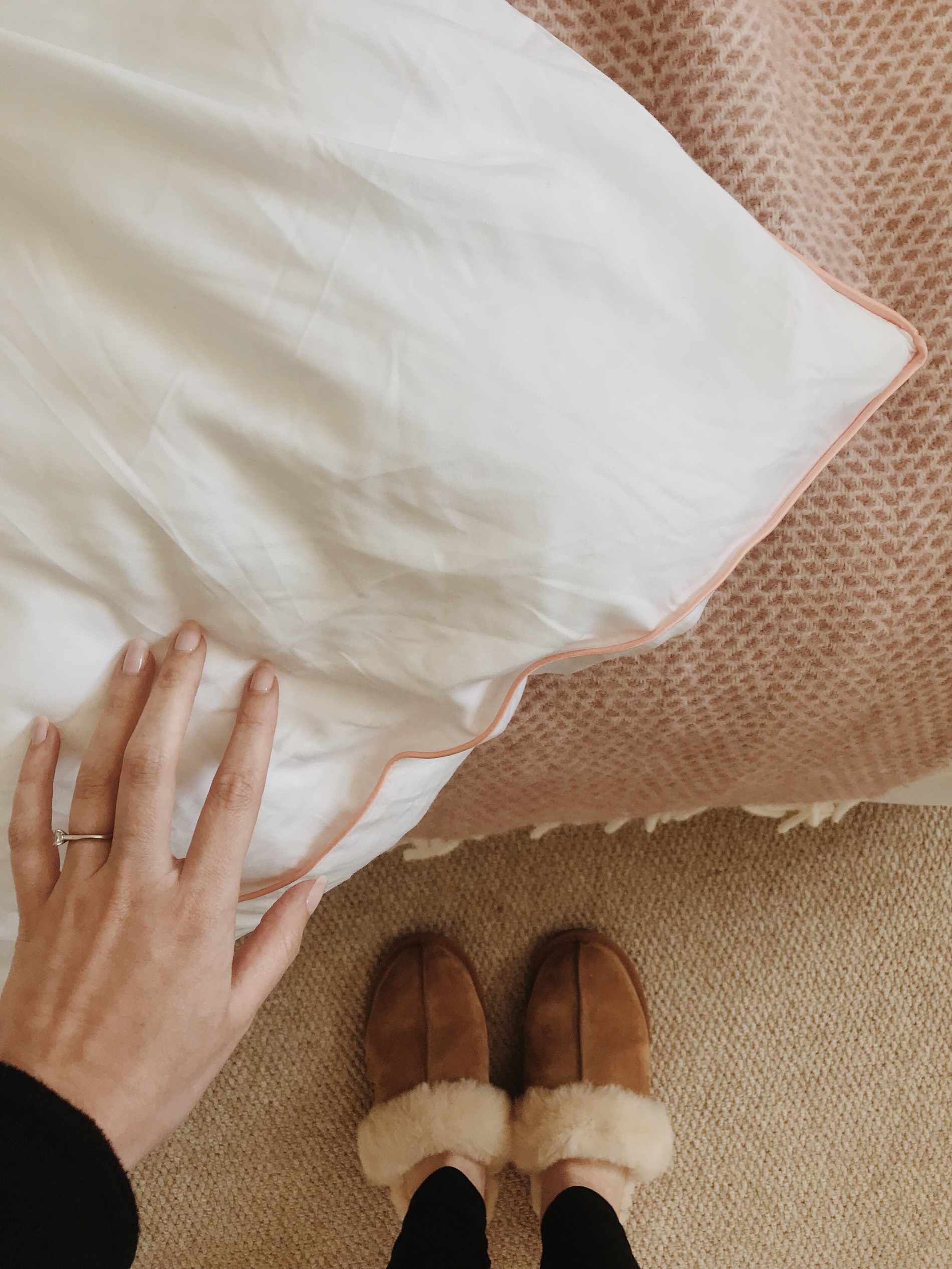 corner of bamboo bedding with woman's hand feeling it
