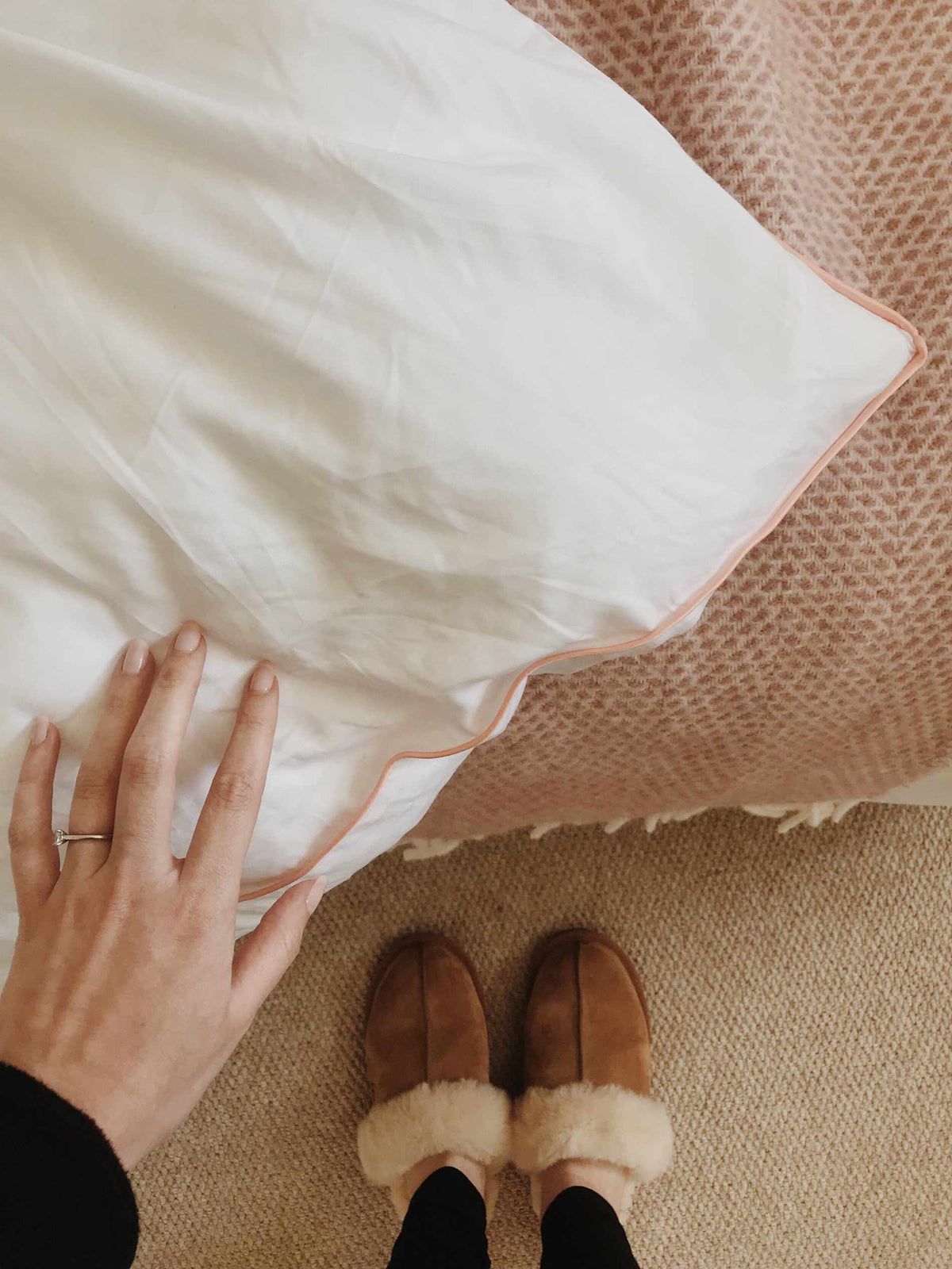 corner of bamboo bedding with woman's hand feeling it